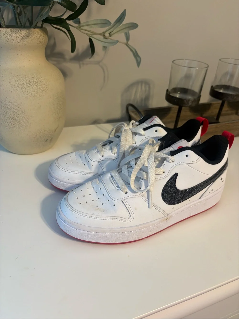 Nike White Low-Top Sneakers with Sparkly Black Swoosh and Red Accents